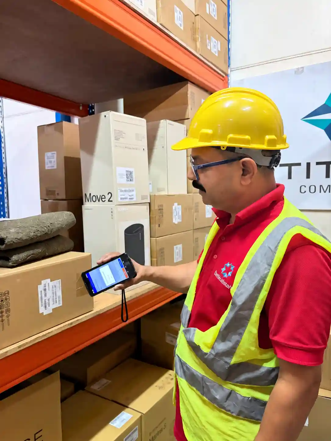 Warehouse team member scanning stock with a handheld barcode terminal