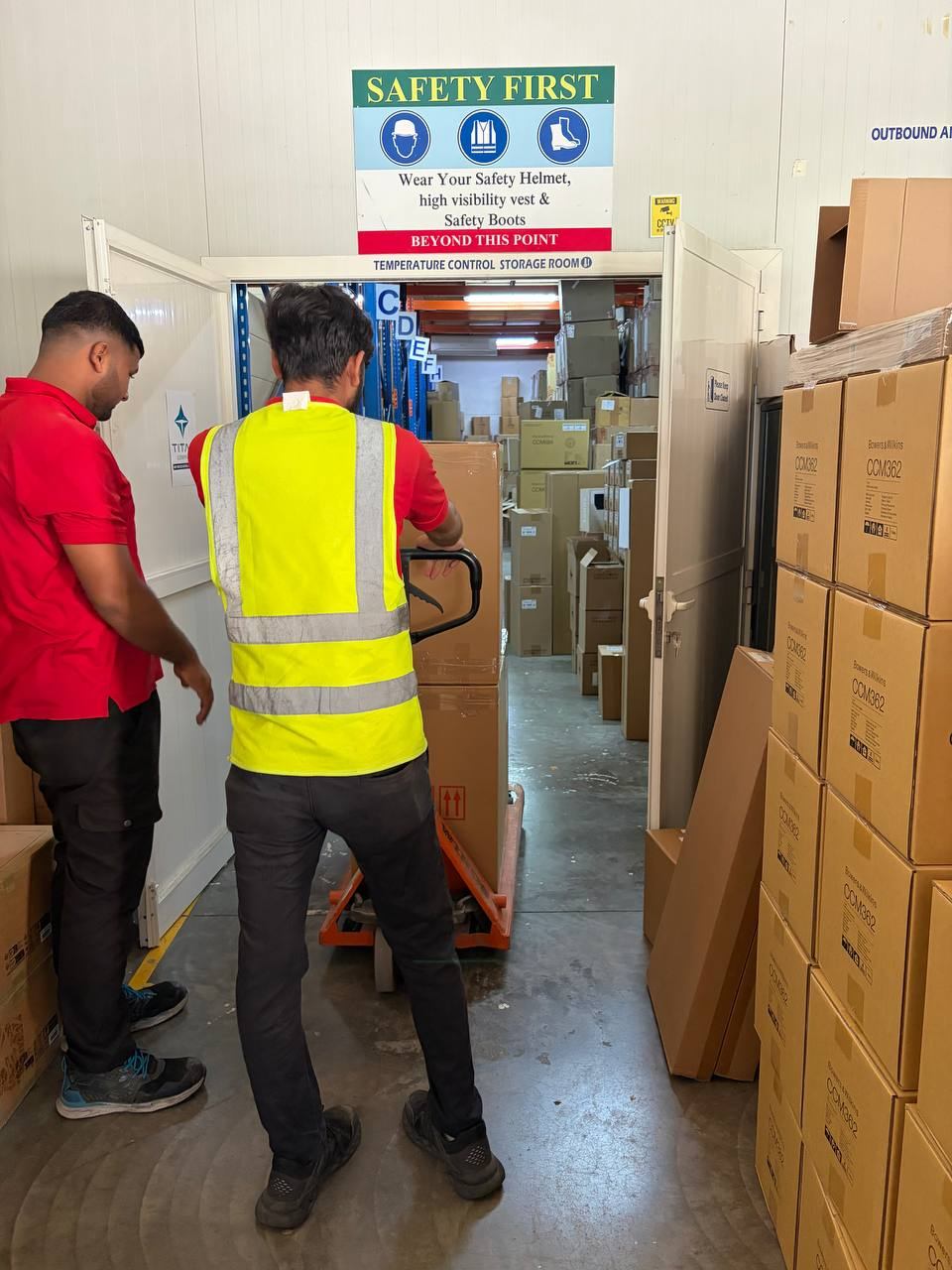 Team members moving stock with a pallet jack