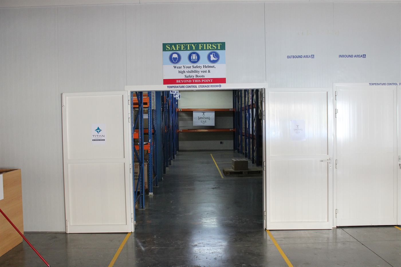 Open doors into the temperature-controlled storage room, with racking inside
